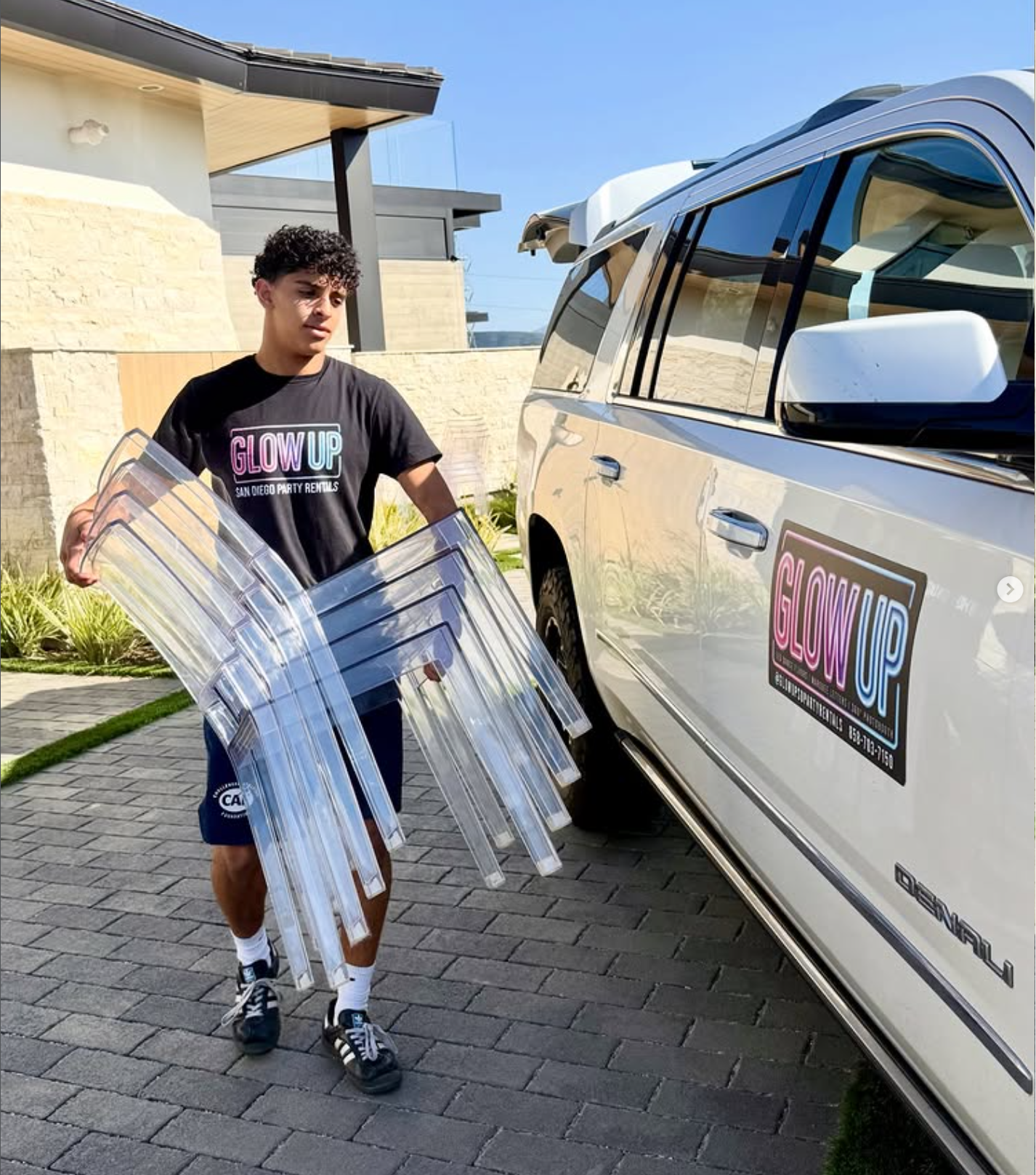 Liam Benhaim delivering acrylic chairs for a Glow Up San Diego event